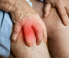 Older person’s hands resting flat on their knee